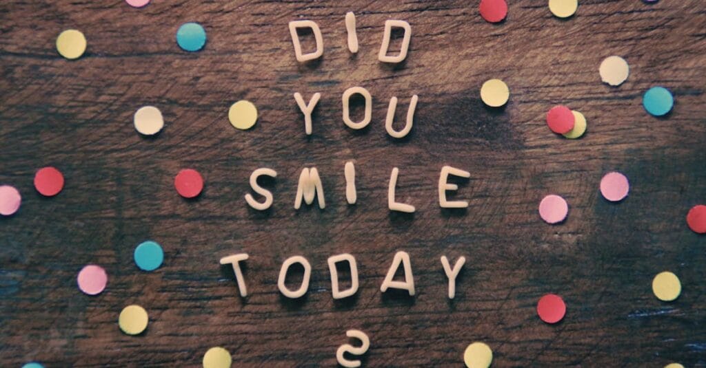 Bright confetti and inspiring text on wooden background with a question: Did you smile today?