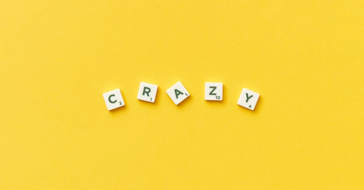 Scrabble tiles spelling 'crazy' on a vibrant yellow background.