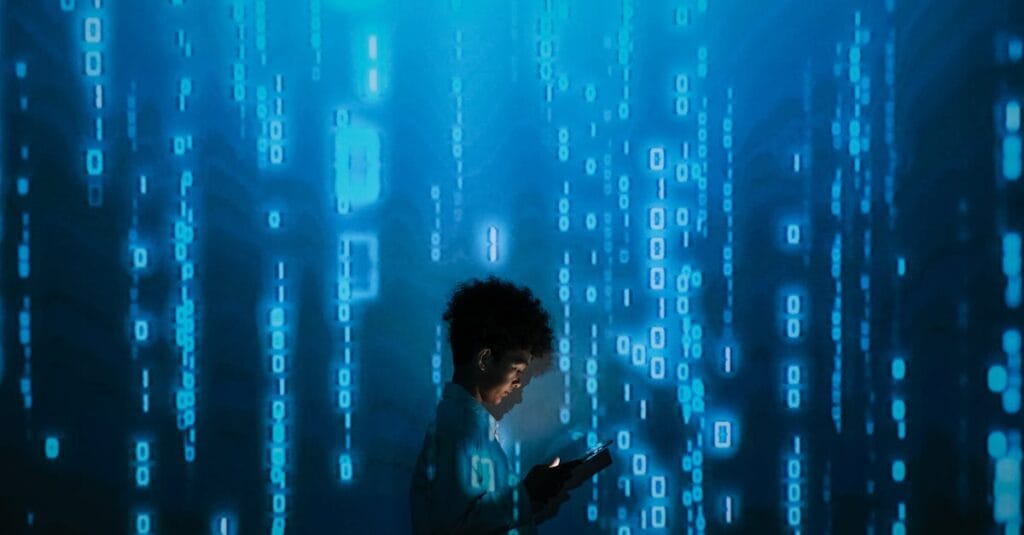 some_pexels-photo-9783812-9783812 Silhouette of a person using a smartphone surrounded by digital binary code projections.