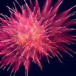 Kun äly muuttui taidoksi A stunning pink firework explodes vividly against a dark night sky.